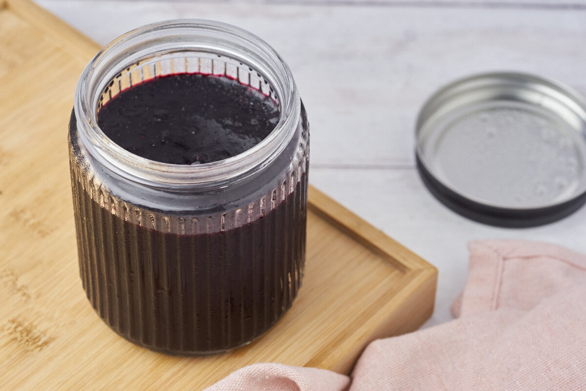 blueberry compote in a jar with the lit off.