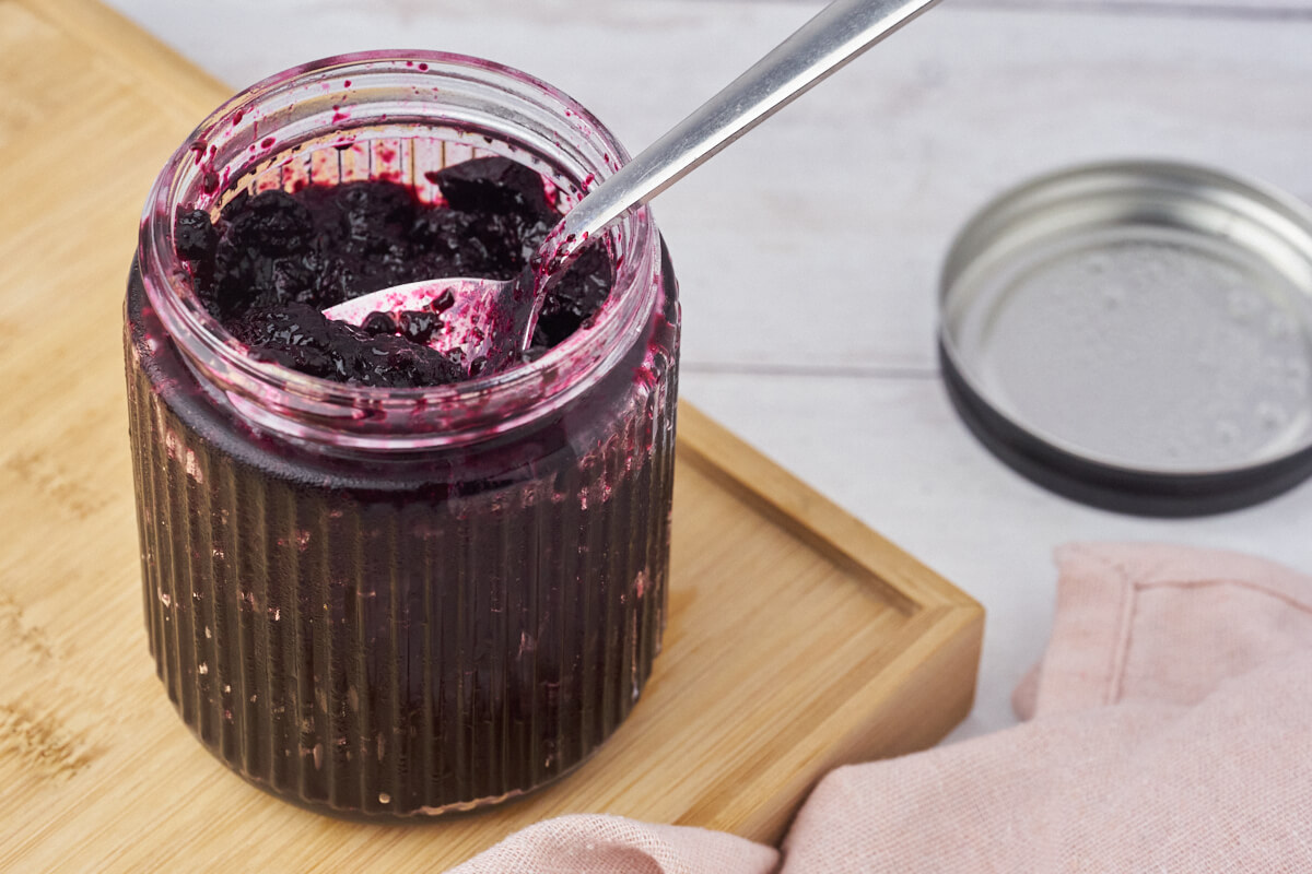 blueberry compote with a spoon in a jar.