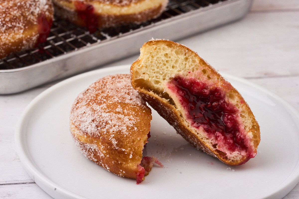 cut over berliner pfannkuchen so you can see the jam in the middle.