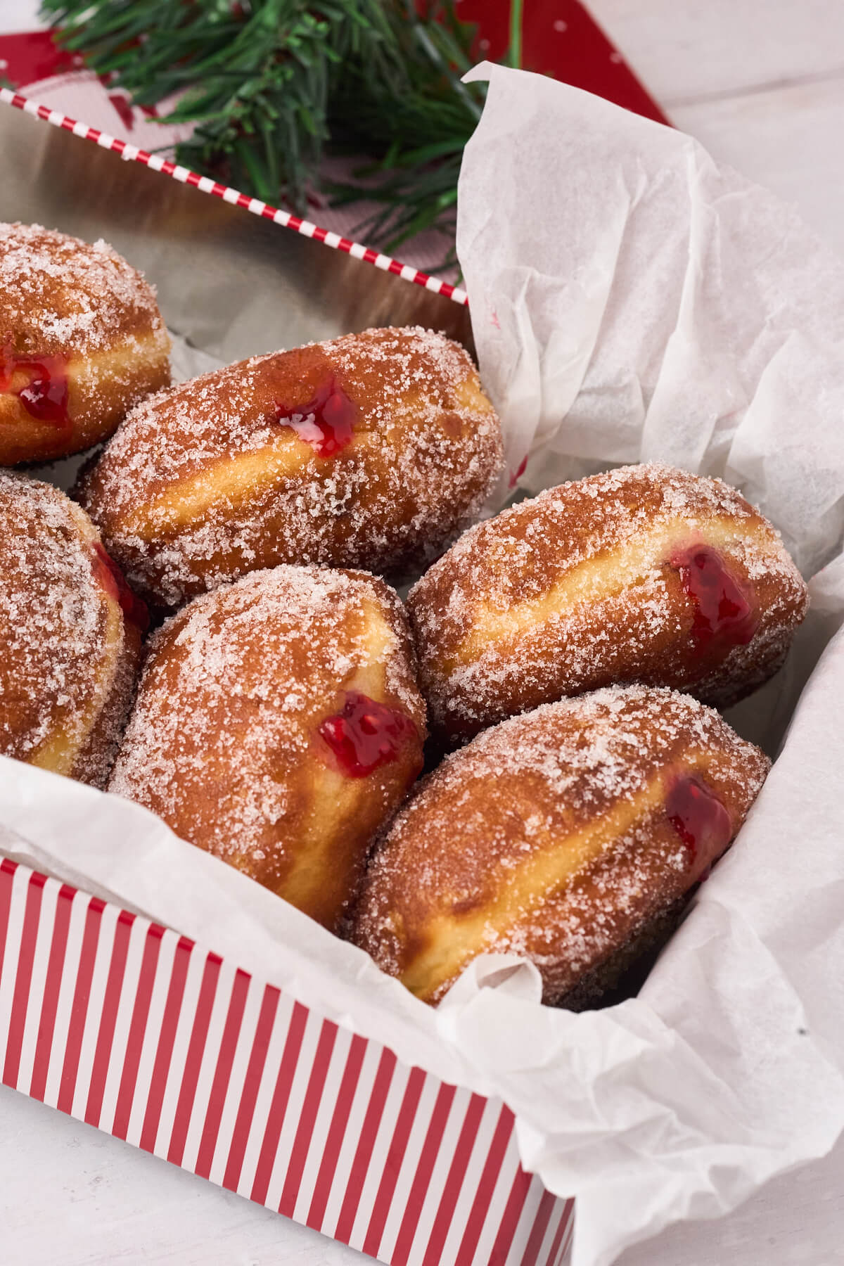 cake tin with home-baked Berliner Pfannkuchen with raspberry jam.