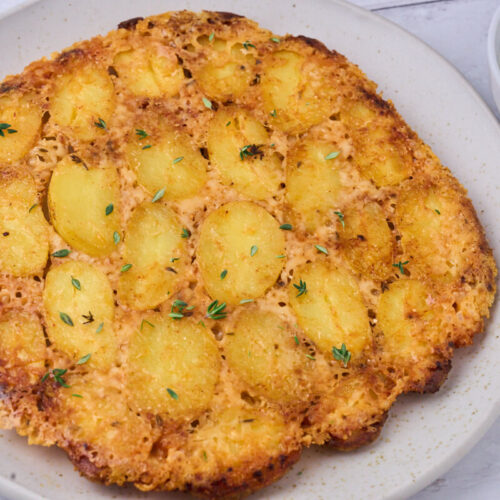 plate with crispy parmesan potatoes and dipping sauce.