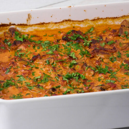 ovenproof dish with pork tenderloin in creamy mushroom sauce.